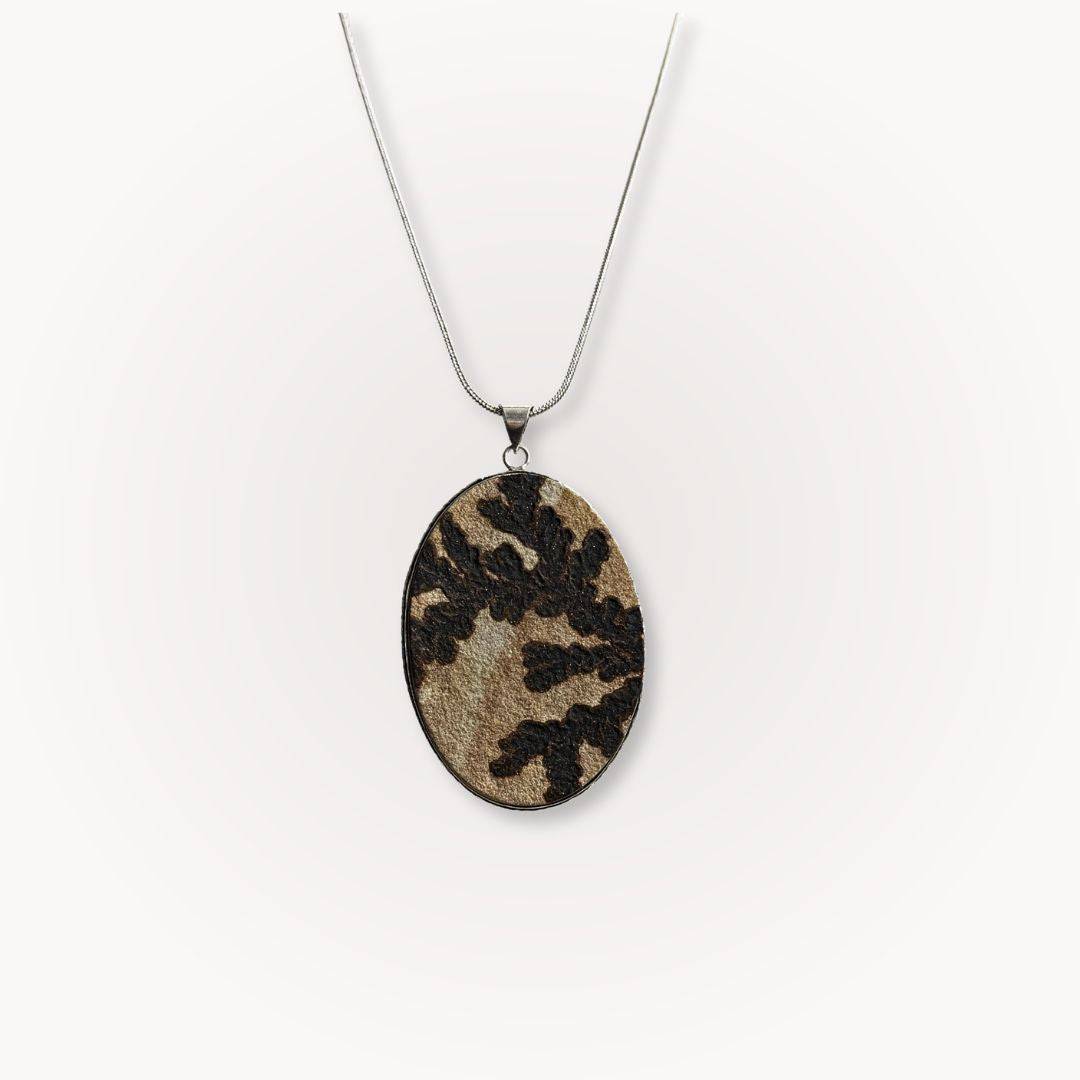 Large Psilomelane Jasper pendant with dendritic patterns on a silver chain. Unique grounding stone for jewelry lovers and spiritual wearers.