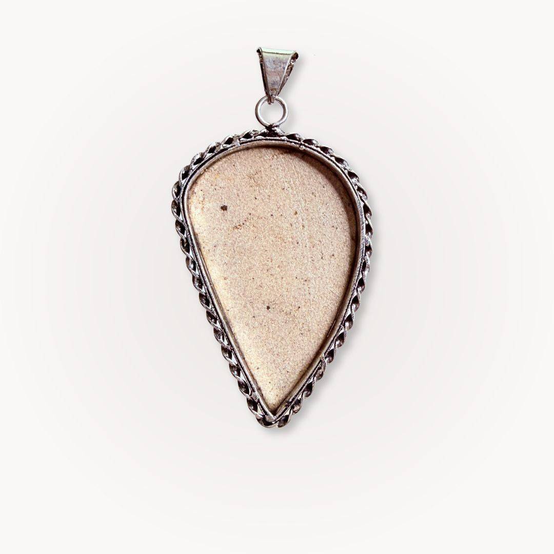 Back view of Psilomelane Jasper Pendant showing smooth beige stone surface. Silver bezel setting with rope detailing.