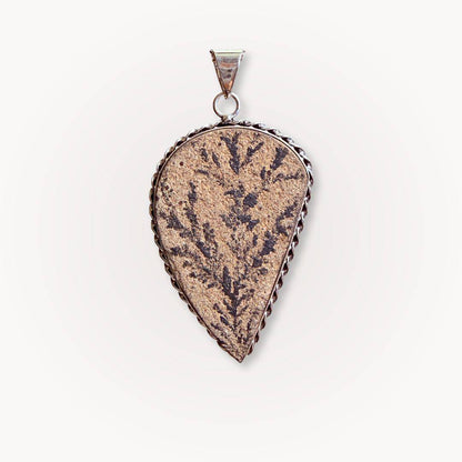 Close-up of Psilomelane Jasper Pendant featuring dark lightning branch inclusions. Teardrop shape set in twisted silver frame.