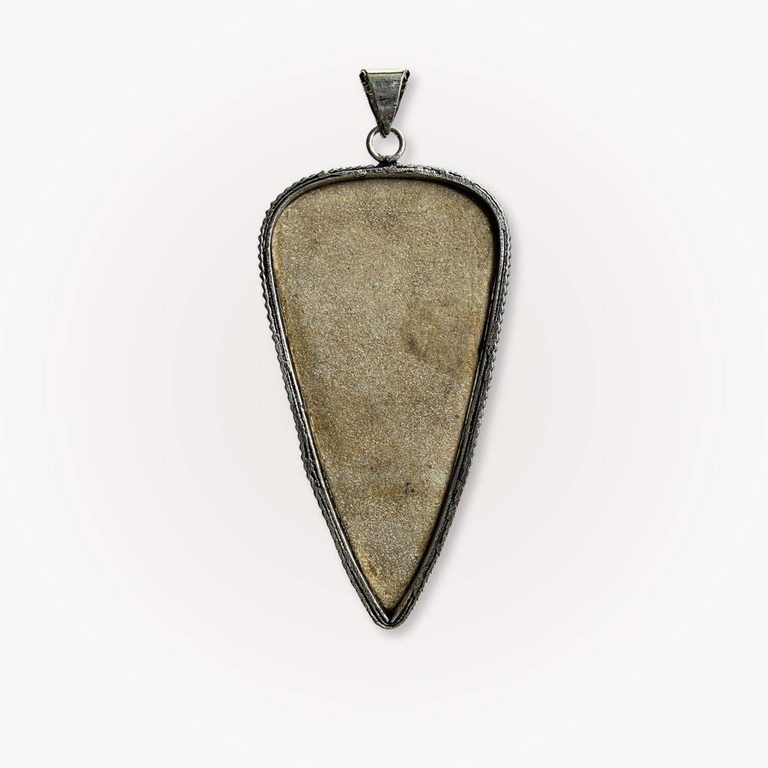 Psilomelane Jasper Pendant | Grounding, Protection, Self-awareness. Back view of the pendant showing smooth, unpolished stone surface and metal frame.