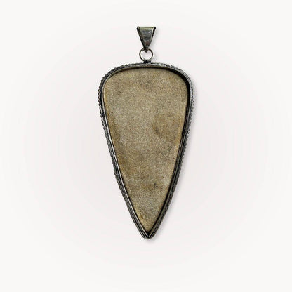 Psilomelane Jasper Pendant | Grounding, Protection, Self-awareness. Back view of the pendant showing smooth, unpolished stone surface and metal frame.