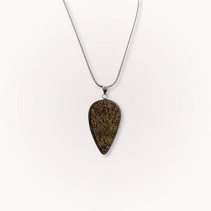 Psilomelane Jasper Pendant with teardrop shape and dendritic veining, suspended on a silver chain. Ideal for grounding and shadow work.