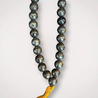 Close-up of Pyrite Mala for Protection & Confidence showing detailed 8mm beads and golden tassel, perfect for prayer and mindfulness.