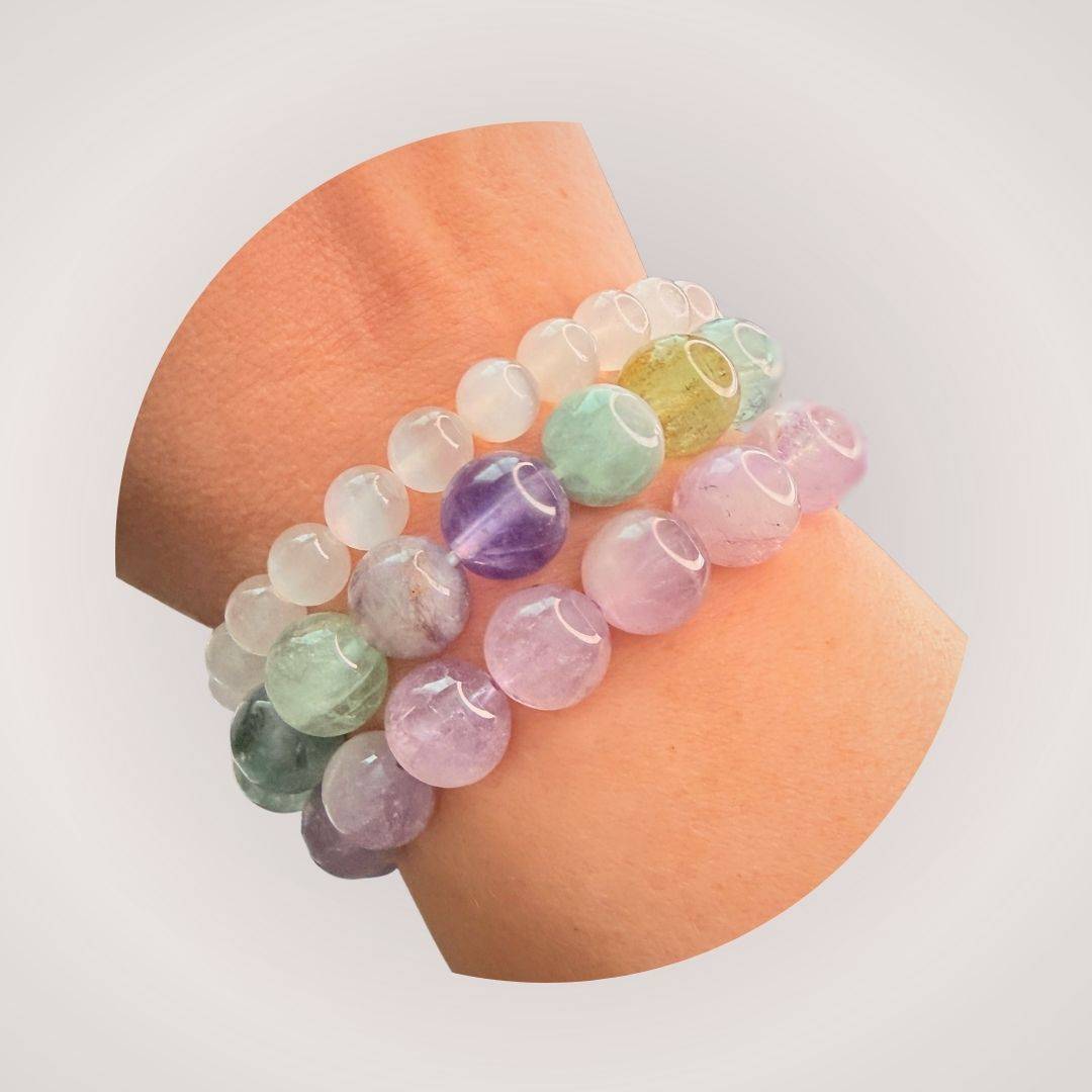 Stacked Rainbow Fluorite 12mm Beaded Bracelet on wrist, showcasing vibrant gemstone colors that promote clarity and intuition in a stylish accessory.