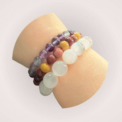 Rainbow Fluorite 8mm Beaded Bracelet worn on wrist with other gemstone bracelets, highlighting its vibrant colors and intuitive energy.