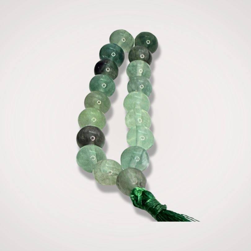 Close-up of Rainbow Fluorite Mala Beads - Clarity Focus | 108 beads, 8mm showing polished green and purple hues with tassel.