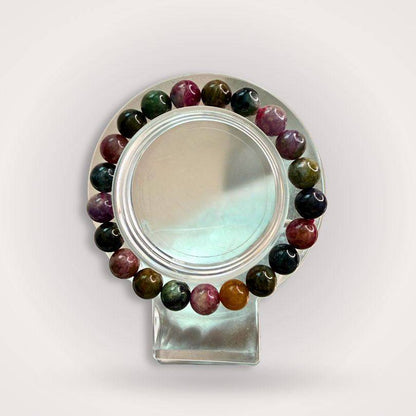 Rainbow Tourmaline Beaded Bracelet 9mm displayed on a clear stand, showcasing multicolored polished beads for emotional balance and heart alignment.