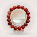 Red Botswana Agate 12mm Beaded Bracelet featuring polished round stones for grounding and emotional stability. Handcrafted jewelry for calm energy.