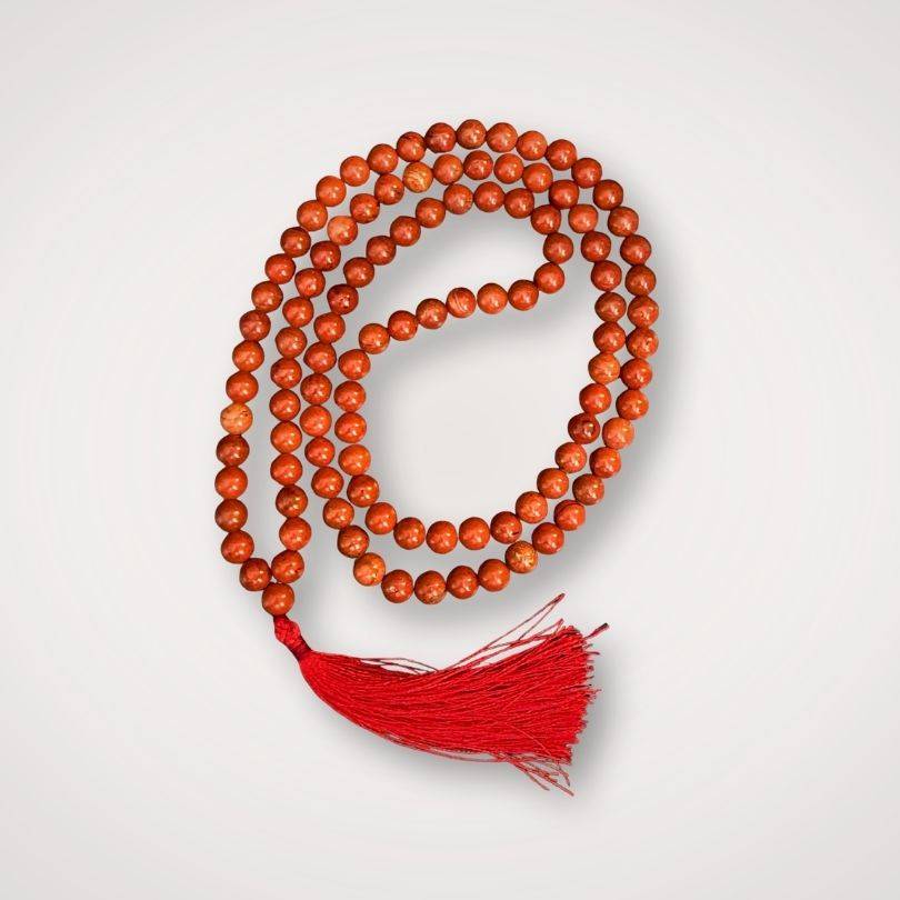 Red Jasper Mala Necklace with 108 polished beads and red tassel, ideal for grounding and strength in meditation practices.