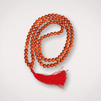 Red Jasper Mala Necklace with 108 polished beads and red tassel, ideal for grounding and strength in meditation practices.