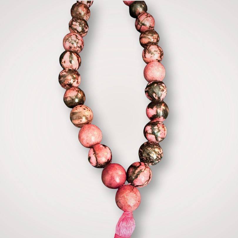 Close-up of Rhodonite Mala Necklace with 8mm beads showcasing natural pink and black patterns, perfect for emotional balance and prayer use.