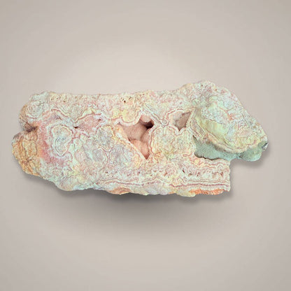 Rhodochrosite stalactite slice with natural pink hues and layered mineral structure