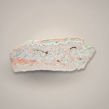 Close-up of Rhodochrosite mineral specimen showcasing colorful banded formation