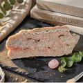 Rhodochrosite stalactite slice with pink banding and intricate mineral layers