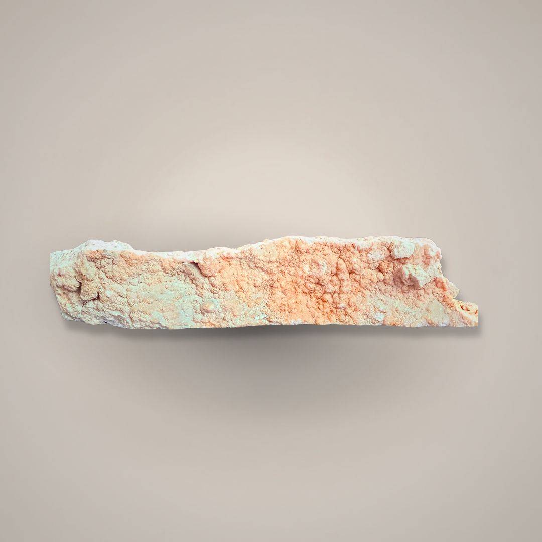 Rhodochrosite stalactite slice with pink banding and rough texture, mineral specimen for collectibles