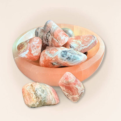 Rhodochrosite tumbled stones in a wooden bowl, pink and white mineral rocks for collectibles and healing