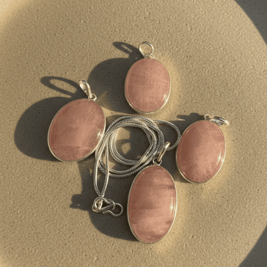 Rose Quartz Oval Pendant in sterling silver setting, showcasing soft pink hues for love and healing. Ideal for emotional wellness jewelry.