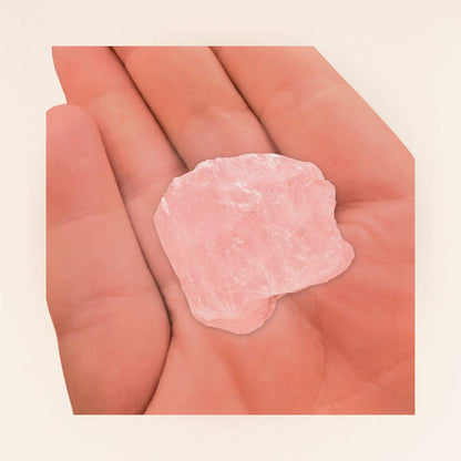 Hand holding a Raw Rose Quartz Crystal, showcasing its size and natural texture for heart healing, self-love, and mindful meditation practices.