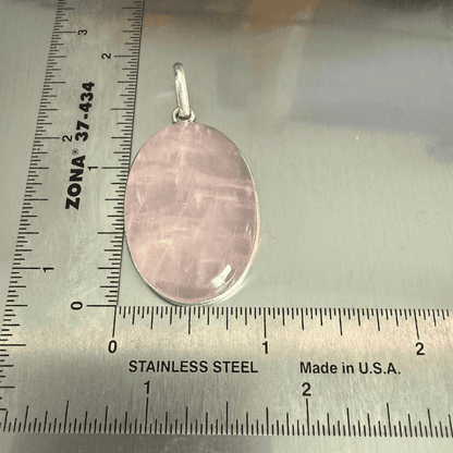 Rose Quartz Oval Pendant - Love & Healing in sterling silver, placed next to a ruler for size reference. Ideal for emotional healing jewelry.
