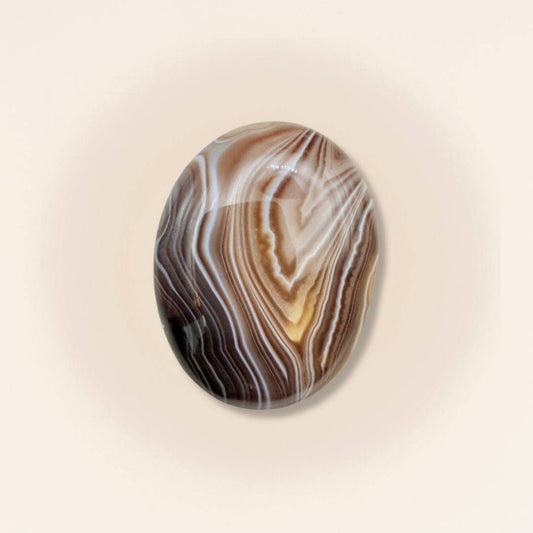 Medium Sardonyx palm stone with polished surface and intricate brown and white banding, ideal for grounding and protection rituals.