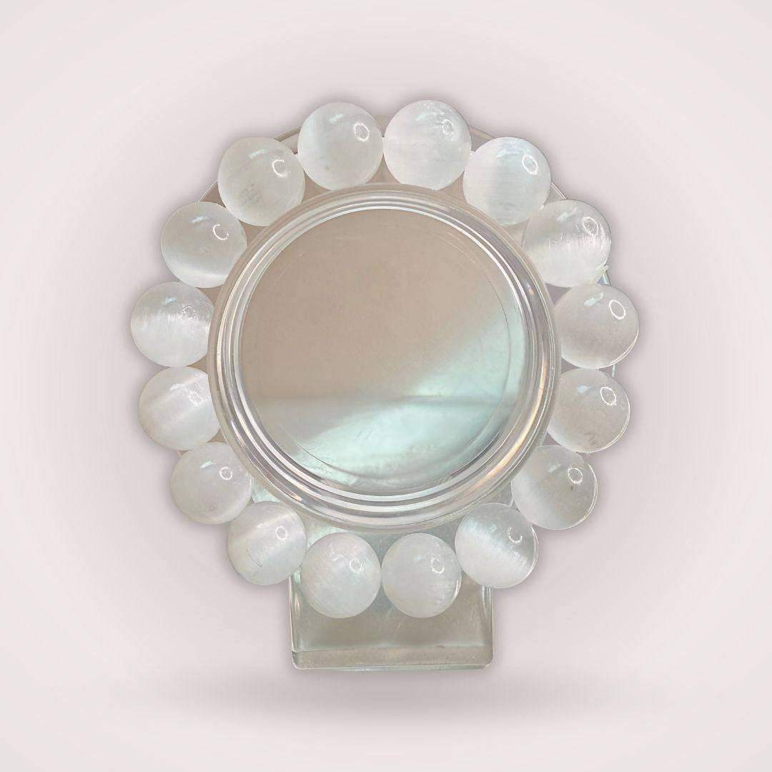 Selenite (Satin Spar) 12mm Beaded Bracelet displayed in a circular arrangement, showcasing its luminous white crystal beads for cleansing energy.
