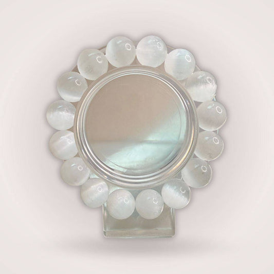 Selenite (Satin Spar) 12mm Beaded Bracelet displayed in a circular arrangement, showcasing its luminous white crystal beads for cleansing energy.