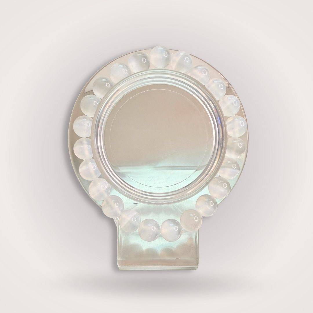 Selenite Beaded Bracelet - 8mm displayed on a round crystal stand, showcasing its translucent white beads for cleansing and clarity.