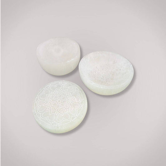 Set of three hand-carved Selenite Charging Plates including a mandala-engraved piece, perfect for ritual cleansing and crystal energy restoration.