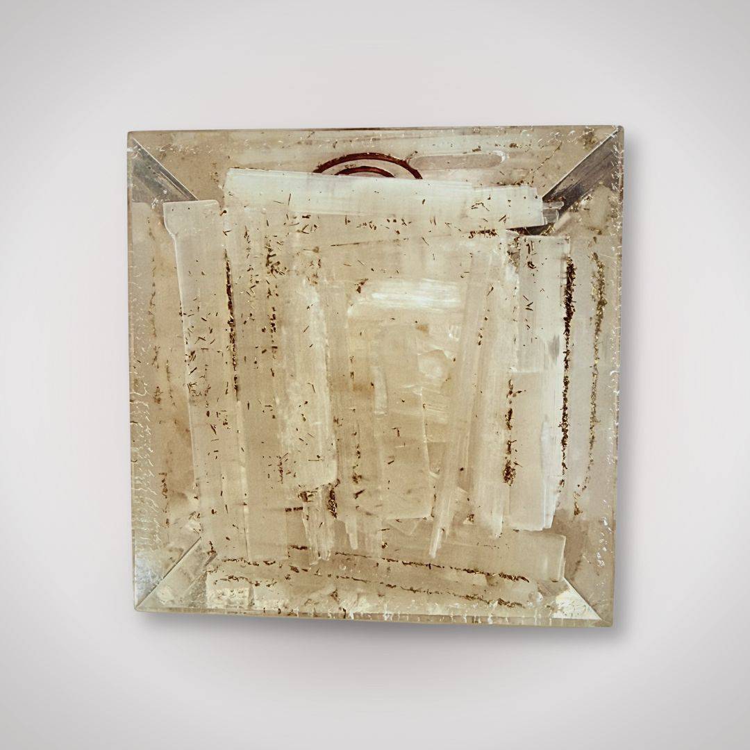 Base of the Selenite Rainbow Orgonite Pyramid showing natural selenite layers, emphasizing its handcrafted and organic crystal structure.