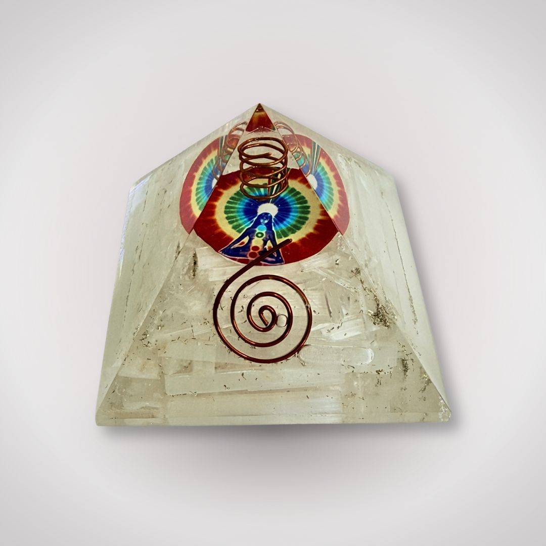Selenite Rainbow Orgonite Pyramid with copper spiral and rainbow symbol, ideal for clarity and energy alignment in home decor or ritual use.