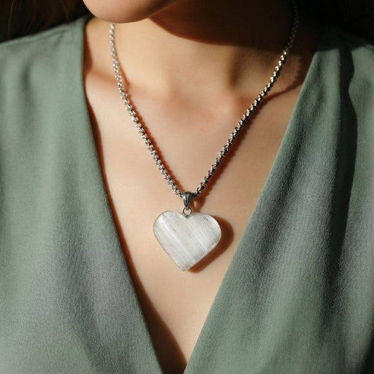 Selenite Raw Front Heart Pendant worn on model, showcasing its elegant design and energy-balancing properties for daily wear.
