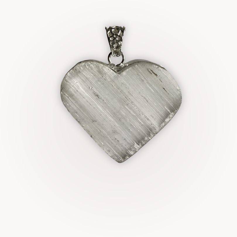 Close-up of Selenite heart pendant from Bond of the Heart aligned pairing, showcasing its radiant texture and silver bail.