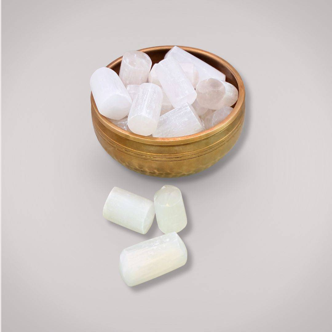 Collection of Selenite tumbled stones in a brass bowl, perfect for gemstone collectors and spiritual cleansing practices.