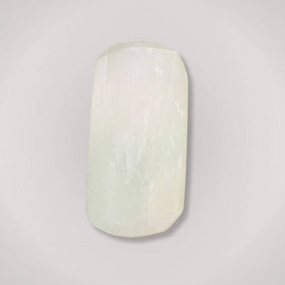 Single Selenite tumbled stone showcasing its smooth satin spar texture, ideal for clarity and energy cleansing rituals.