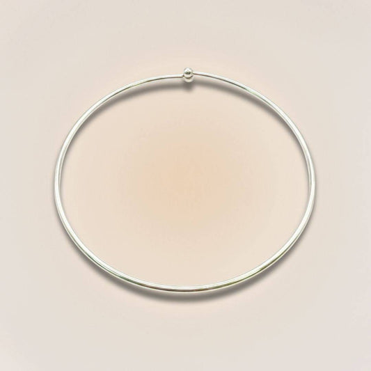 Sterling silver plated adjustable choker with minimalist collar design, ideal for layering or wearing solo. Sleek and modern jewelry piece.