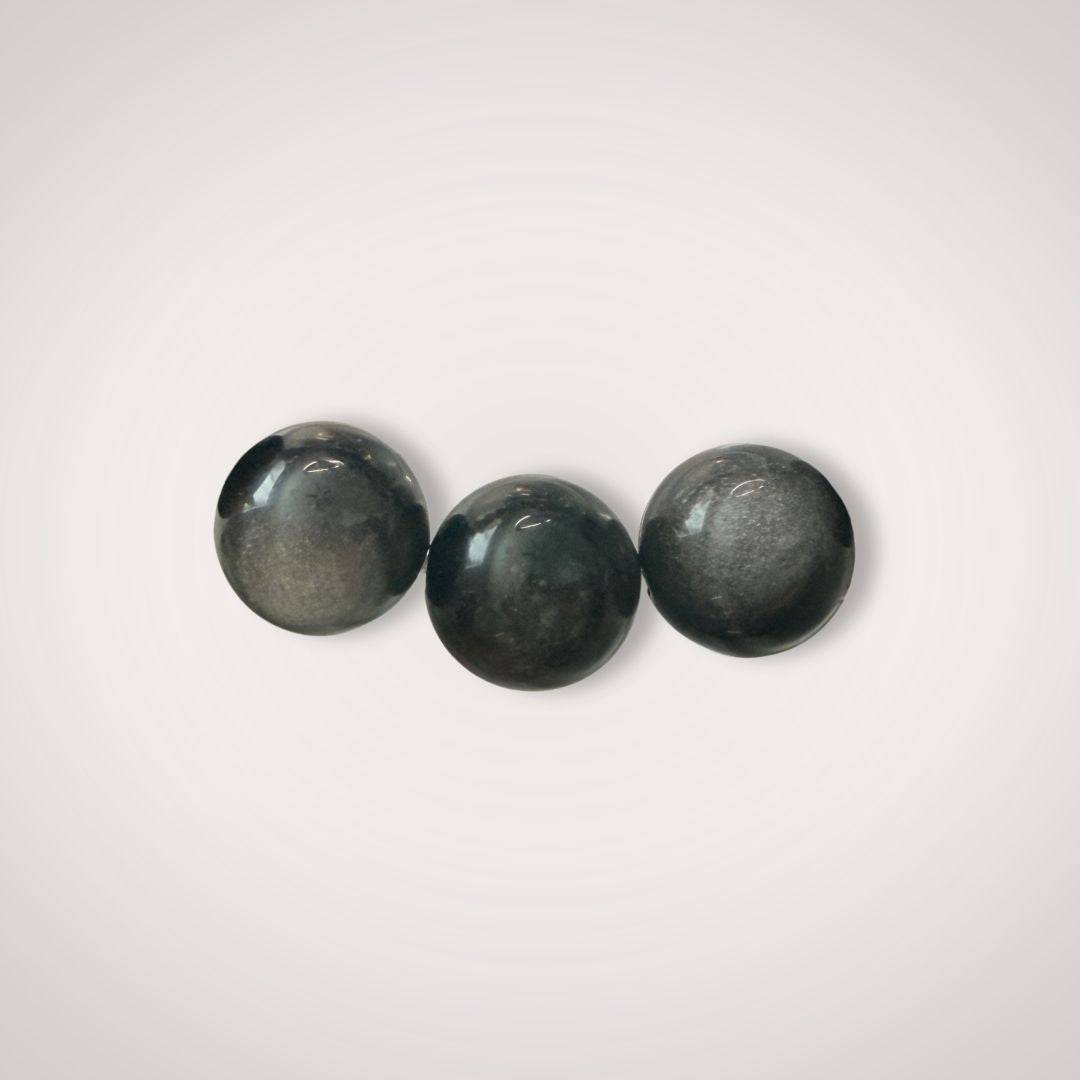 Close-up of three 12mm Silver Obsidian beads highlighting their smooth finish and metallic luster, ideal for grounding and shadow work jewelry.