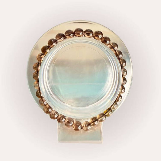 Smoky Quartz Bracelet - 6mm Brazil displayed in a circular arrangement, showcasing polished brown beads for grounding and protection.