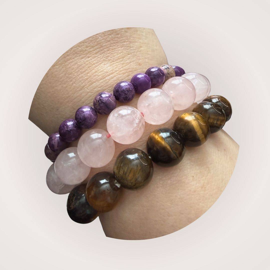 Stacked beaded bracelets featuring Stichtite 8mm beads alongside rose quartz and tiger's eye. Ideal for emotional healing and calming energy.