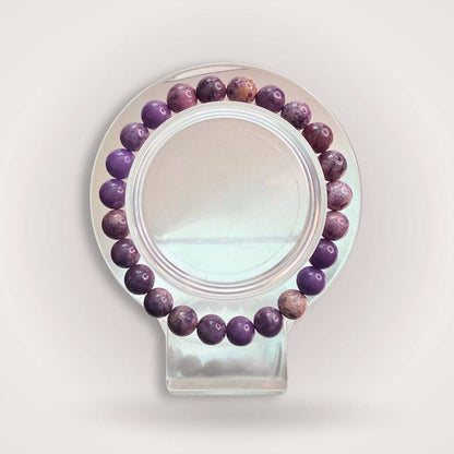 Stichtite Emotional Healing Bracelet with 8mm natural purple beads, displayed on a clear stand for inner calm and emotional balance.