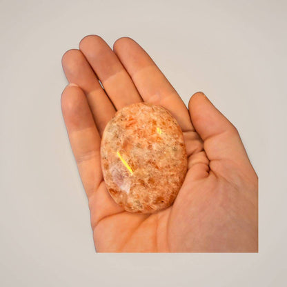 Sunstone palm stone in hand for meditation