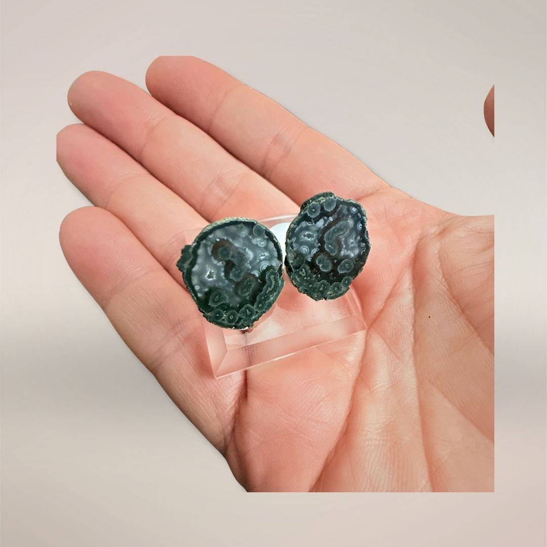 Blue-green Tabasco agate micro-geode pair on display stand
