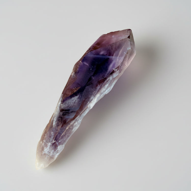 Terminated Phantom Amethyst Root Crystal from Brazil showcasing deep purple phantom inclusions, ideal for intuition and spiritual growth rituals.