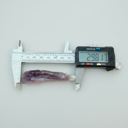 Phantom Amethyst Root Crystal from Brazil measured at 2.98in with digital caliper, showcasing natural termination and deep purple hues.