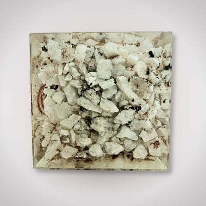 Bottom view of Tourmalinated Quartz Orgonite Pyramid featuring natural quartz chips and copper coil for grounding energy in home decor.