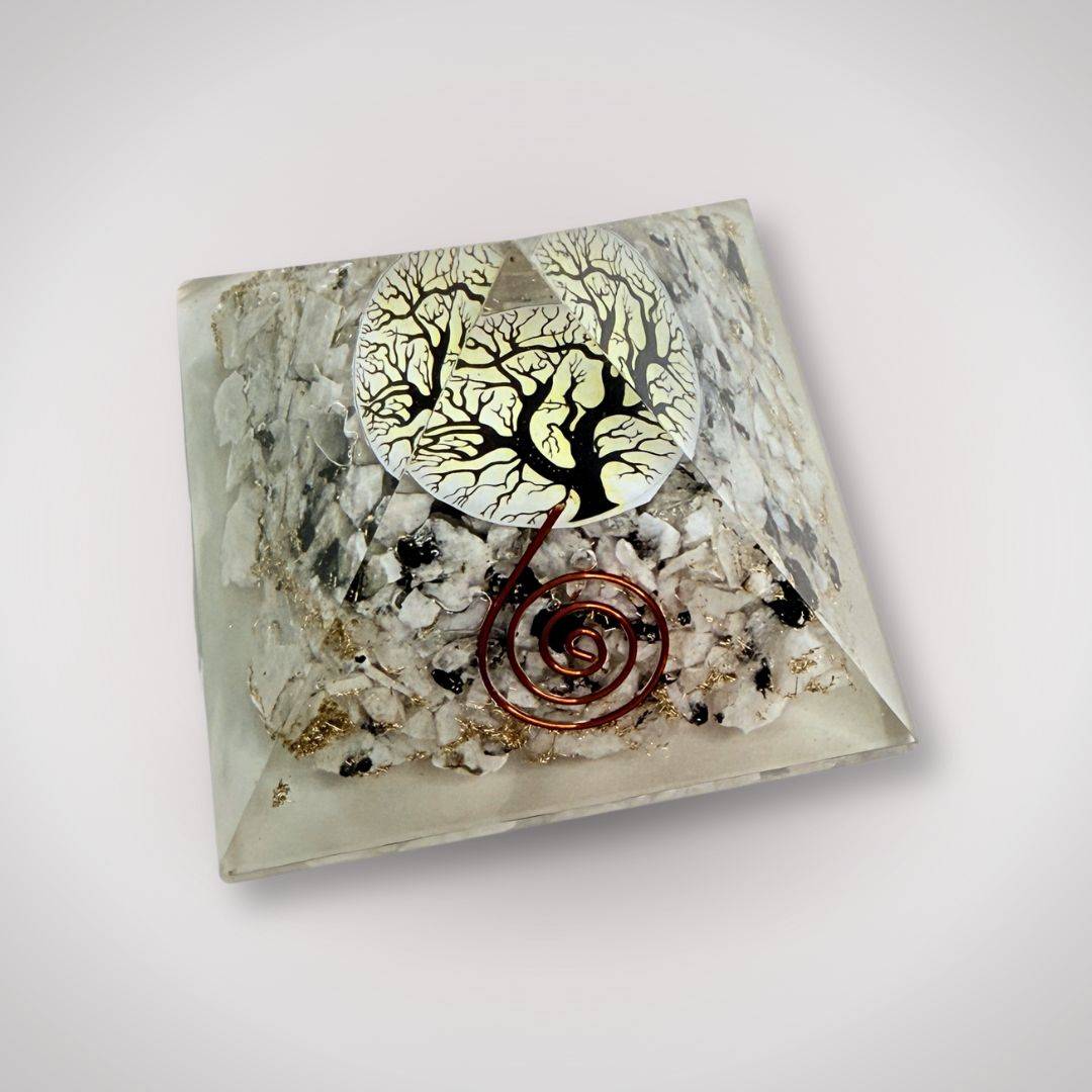 Angled view of handcrafted Orgonite Pyramid with Tree of Life and copper spiral, made with tourmalinated quartz for grounding energy in rituals.