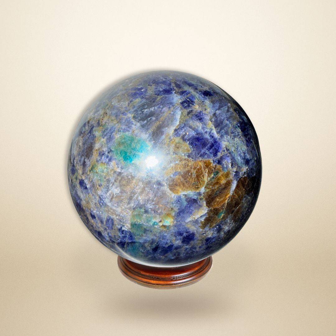 Trinity Stone Sphere 348g • Heart–Mind Alignment Crystal with deep blue, green, and golden hues on a wooden stand, ideal for energy balancing.