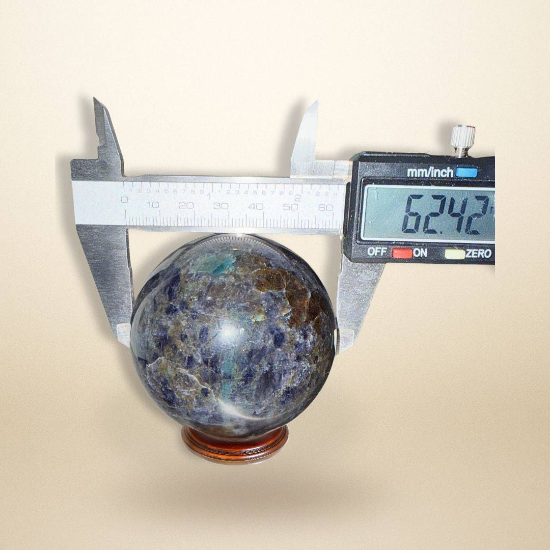 Trinity Stone Sphere 348g measured at 62.42mm diameter with calipers, emphasizing its size and quality for gemstone collectors.