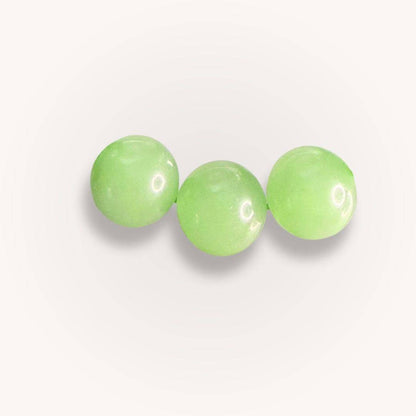 Close-up of three Xiuyan Serpentine 12mm beads highlighting their polished green surface, perfect for calm renewal crystal jewelry collections.