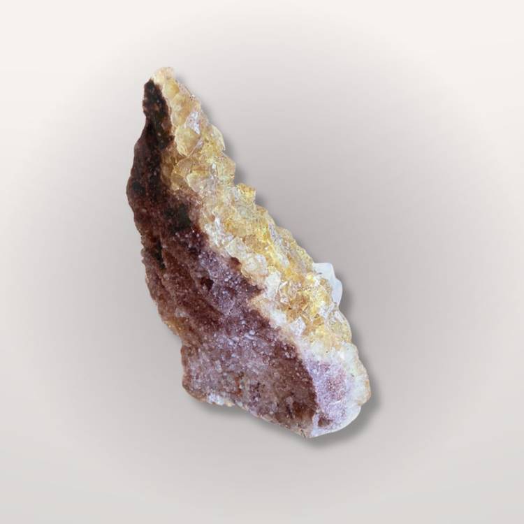 Angled view of yellow fluorite crystal with visible layering and matrix, showcasing its natural origin and collector appeal.