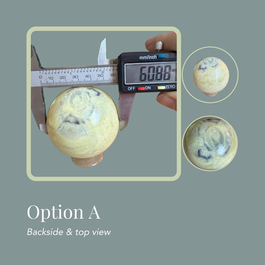 Infinite Stone sphere Option A—creamy yellow green gray swirls and soft banding, multi view.  View of sphere measured with digital caliper reading 60.88 mm diameter